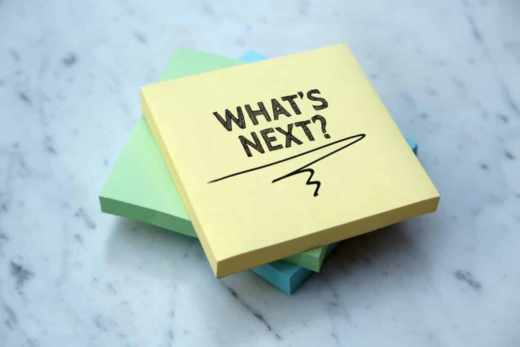 A stack of colored post its with "What's Next?" written on the top post it.