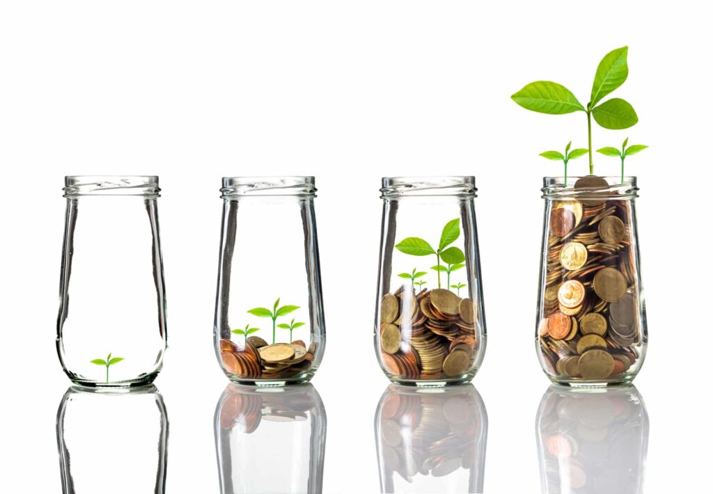 Gold coins and seed in clear bottle on white background, grow your business concept
