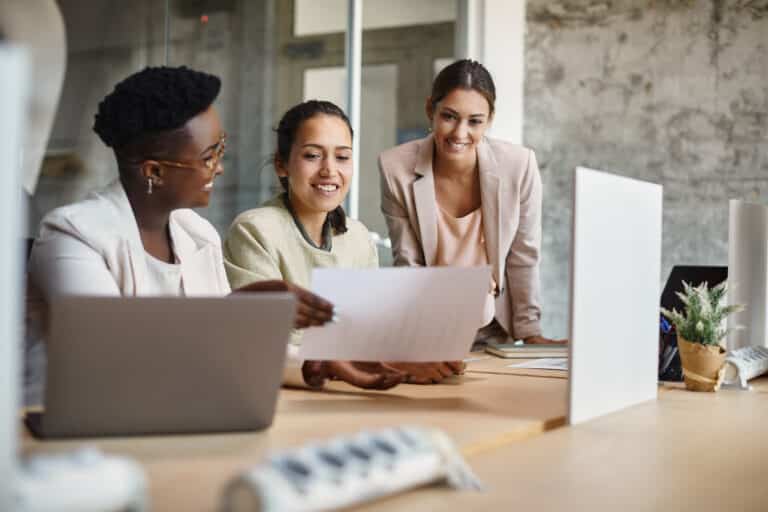 annual planning concept with group of businesswomen examining business progress.