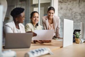 annual planning concept with group of businesswomen examining business progress.