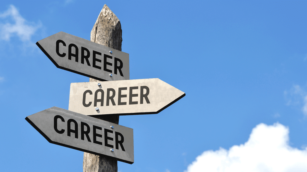 Wooden signpost with multiple arrows, all pointing in different directions and labeled “Career,” against a blue sky.