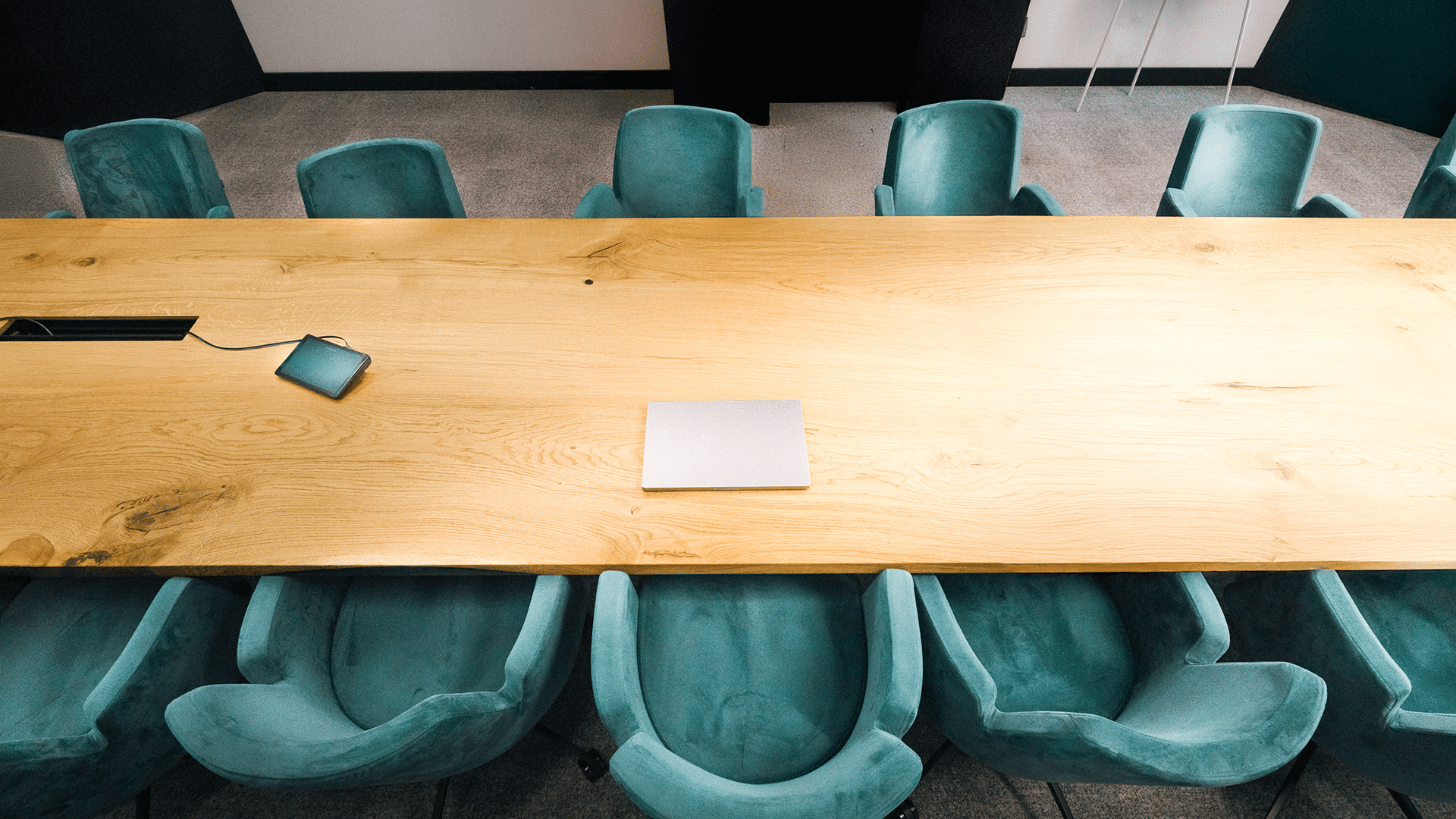 Empty boardroom table with a closed laptop, symbolizing fractional COO services