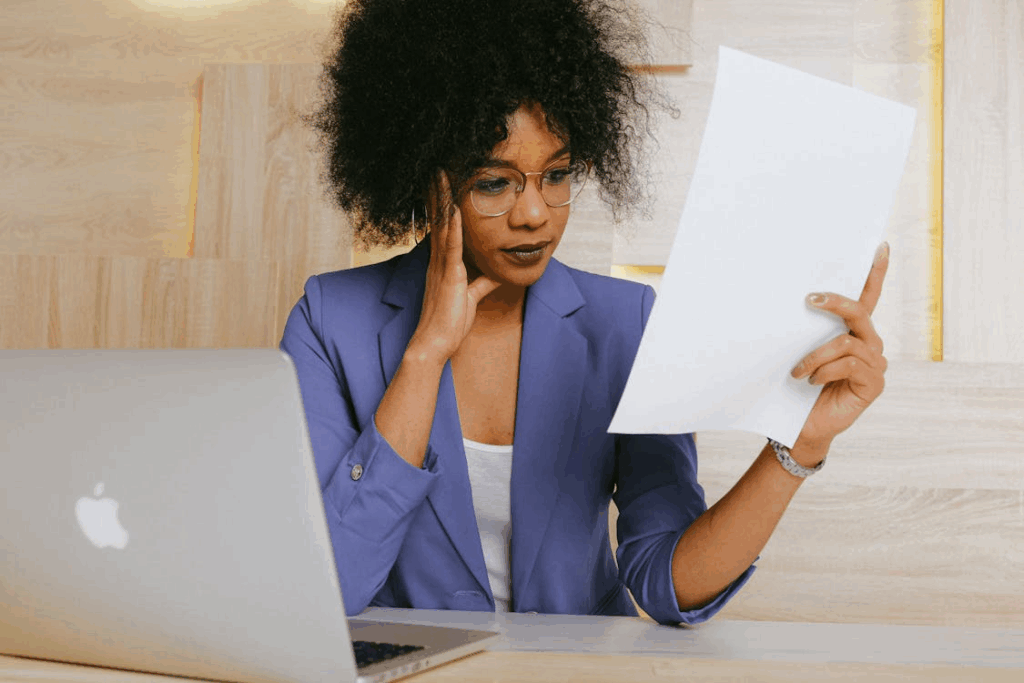 Woman reviewing document at desk.
