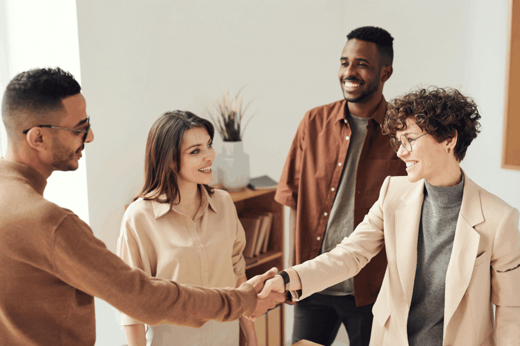 Group of people shaking hands.